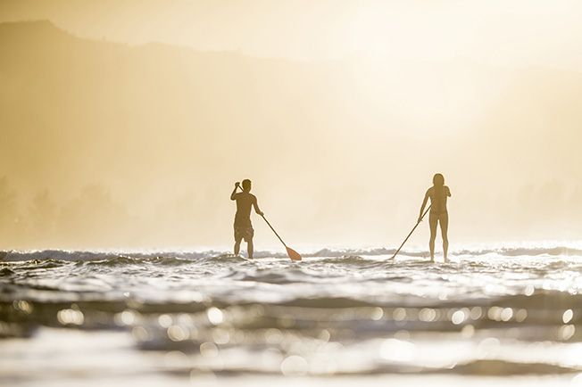 Couple stand up paddleboarding SUP